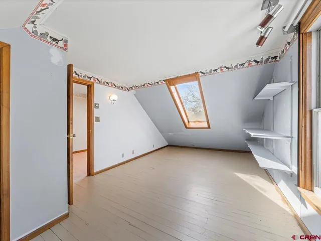 a view of an empty room with wooden walls