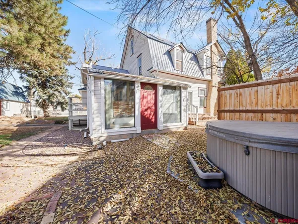 a view of a house with a yard covered in snow