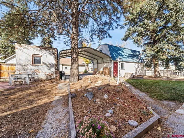 a view of a yard with snow on the road