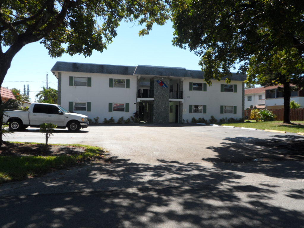 336 Southwest 1st Street, Unit B8 Pompano Beach, FL 33060 - Photo 1 of 11 a front view of a house with a yard