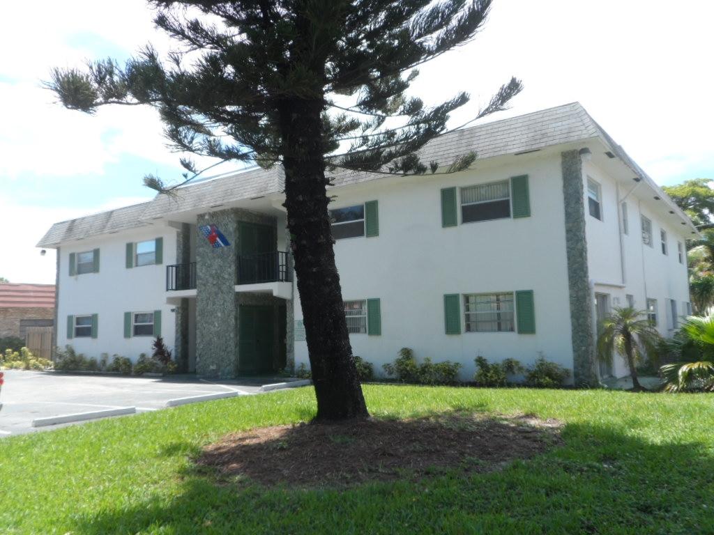336 Southwest 1st Street, Unit B8 Pompano Beach, FL 33060 - Photo 11 of 11 a white house that has a tree in front of the house
