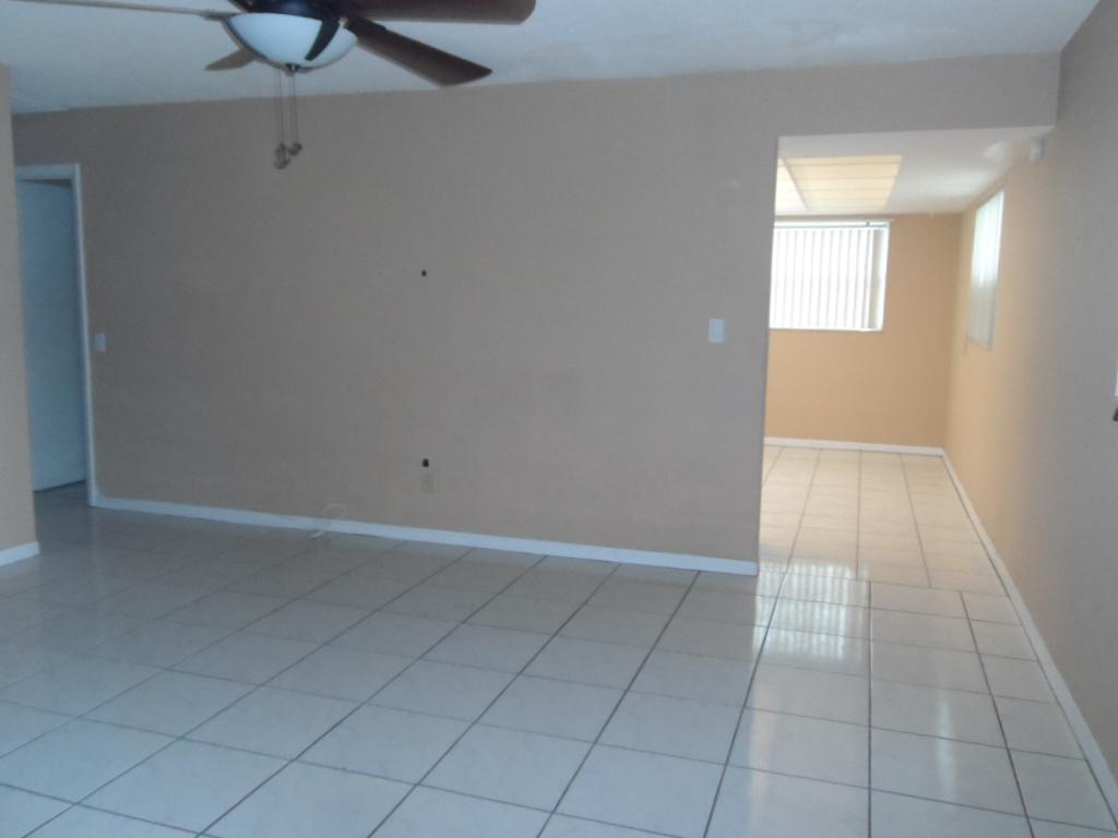 336 Southwest 1st Street, Unit B8 Pompano Beach, FL 33060 - Photo 2 of 11 an empty room with fan and windows
