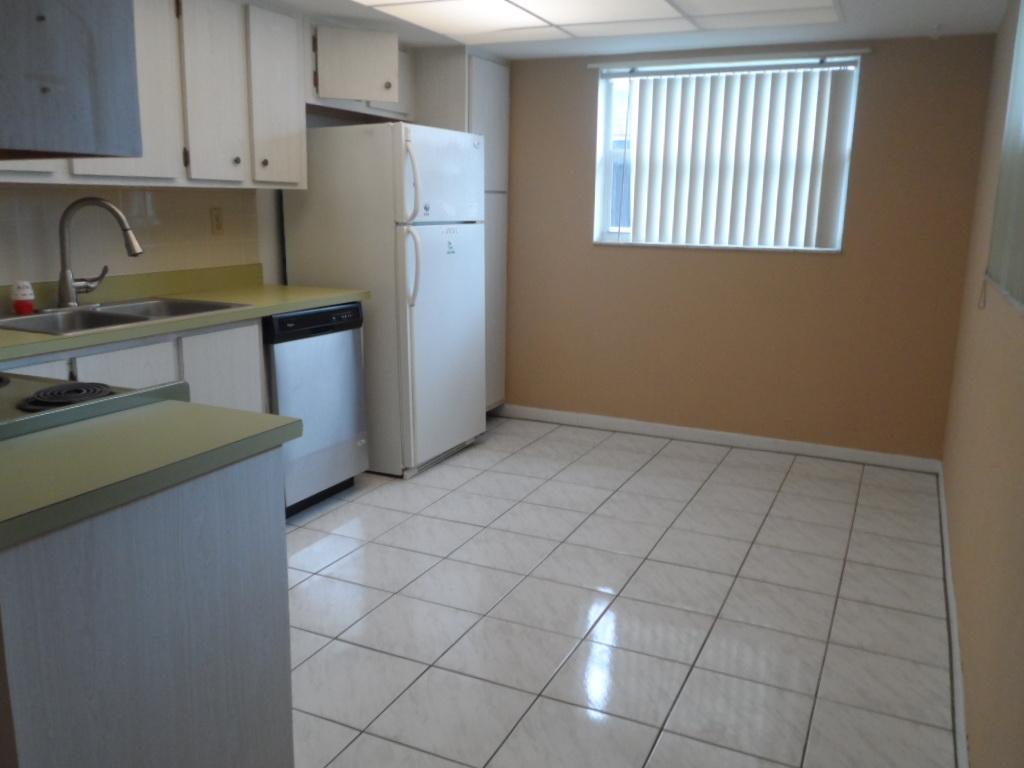 336 Southwest 1st Street, Unit B8 Pompano Beach, FL 33060 - Photo 7 of 11 a kitchen with a sink a refrigerator and cabinets