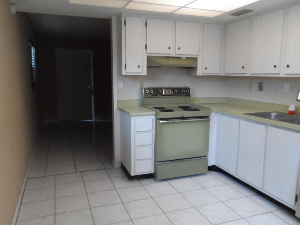 336 Southwest 1st Street, Unit B8 Pompano Beach, FL 33060 - Photo 8 of 11 a kitchen with cabinets and appliances