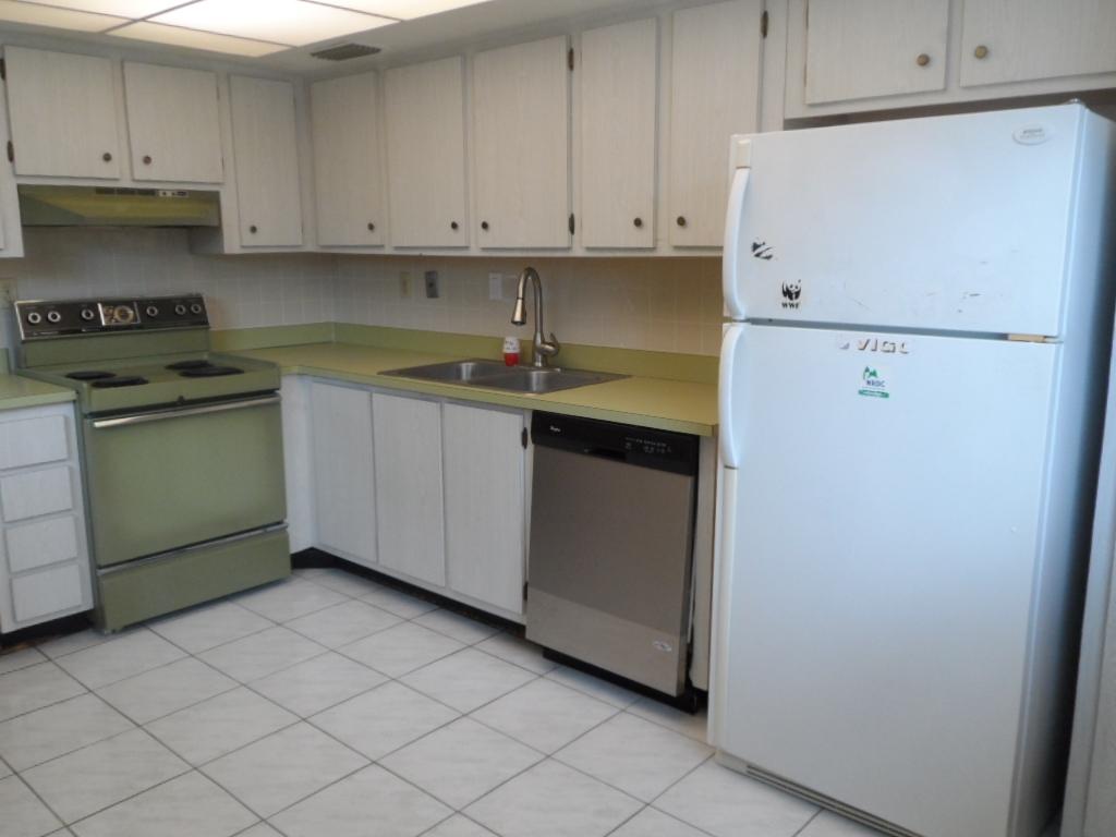 336 Southwest 1st Street, Unit B8 Pompano Beach, FL 33060 - Photo 9 of 11 a kitchen with granite countertop cabinets and white appliances