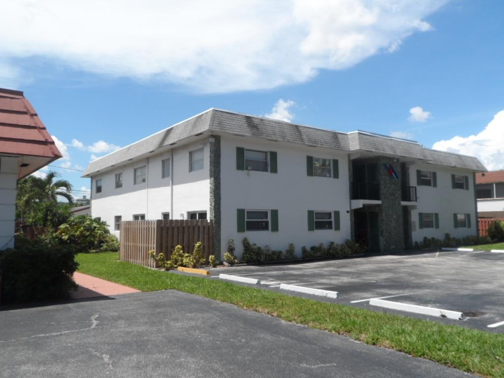 336 Southwest 1st Street, Unit B8 Pompano Beach, FL 33060 - Photo 10 of 11 a front view of a house with a yard and garage