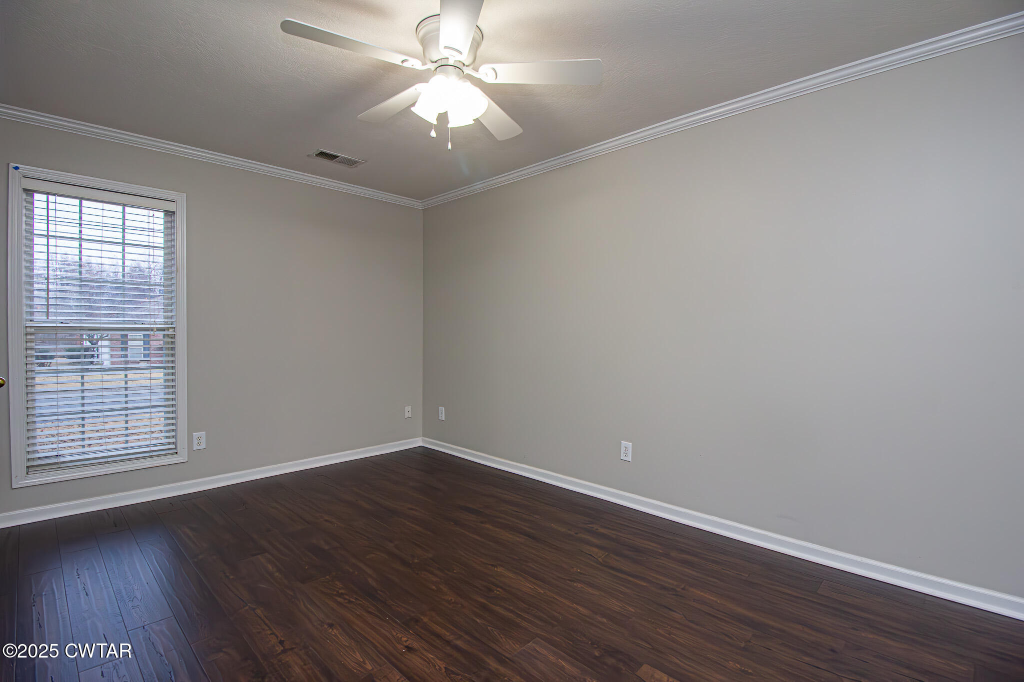 88 Rooker Drive Jackson, TN 38305 - Photo 13 of 20 an empty room with wooden floor and windows