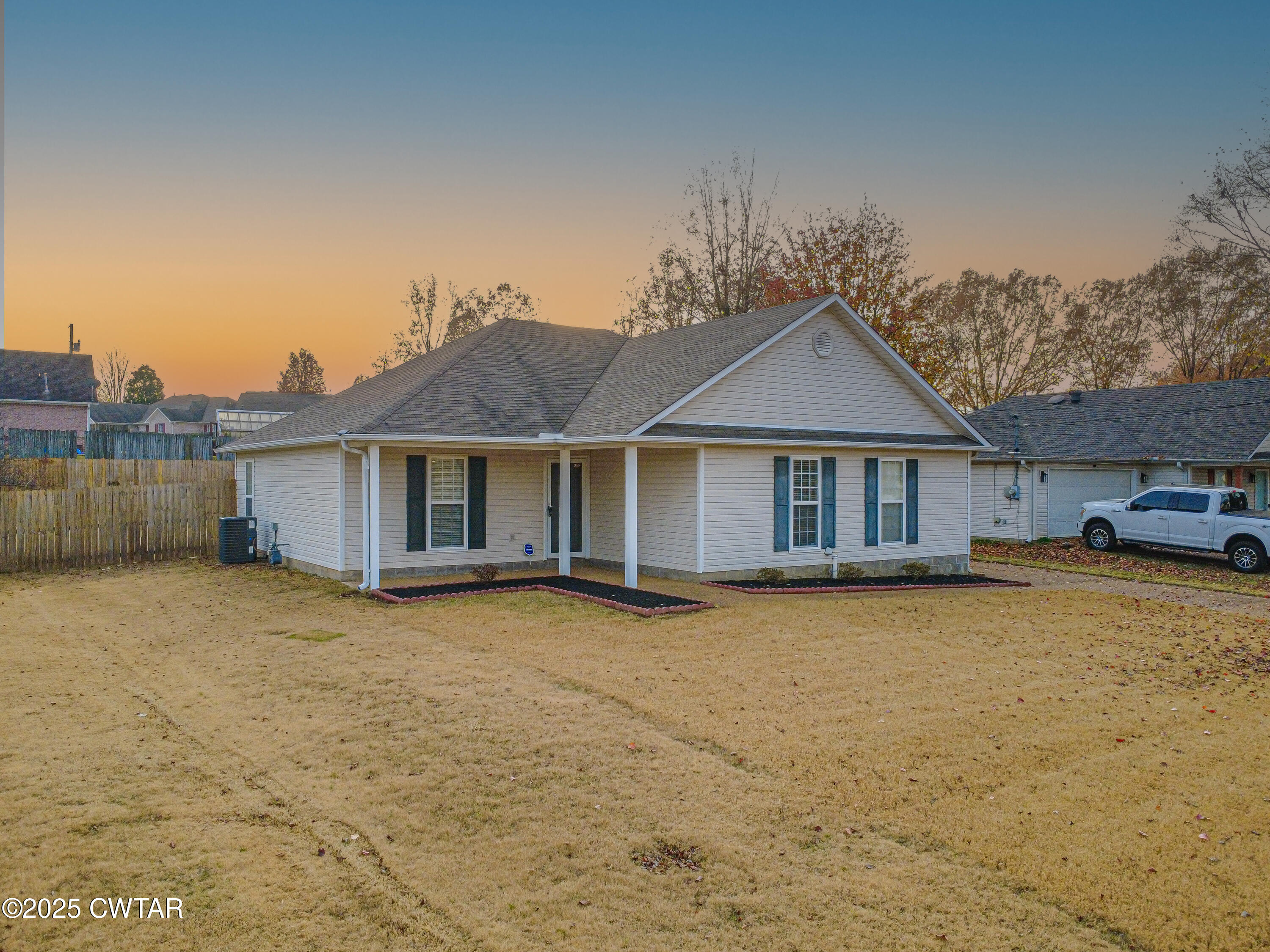 88 Rooker Drive Jackson, TN 38305 - Photo 2 of 20 a front view of a house with a garden and yard