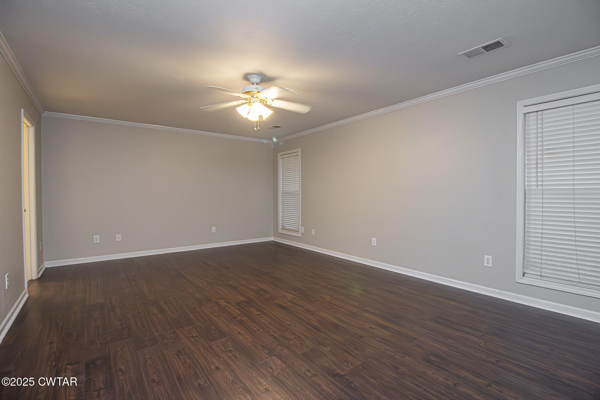 88 Rooker Drive Jackson, TN 38305 - Photo 9 of 20 a view of an empty room with wooden floor and fan