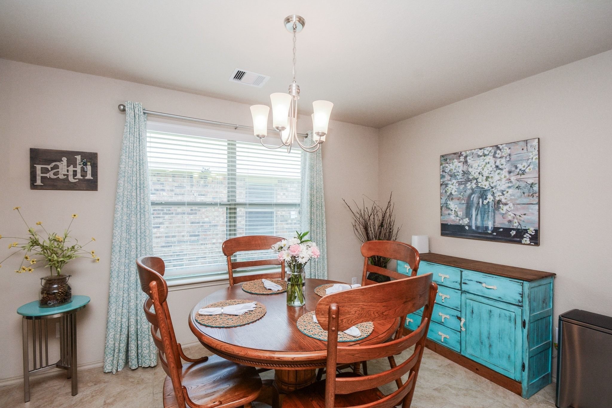 23318 Dukes Run Drive Spring, TX 77373 - Photo 12 of 41 This cozy dining area features a large window which allows natural light, complemented by a modern chandelier for a warm ambiance.