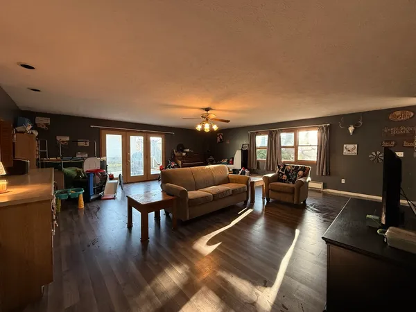 a living room with furniture and wooden floor