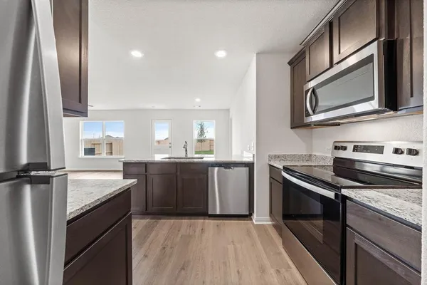 a kitchen with a sink stove and microwave