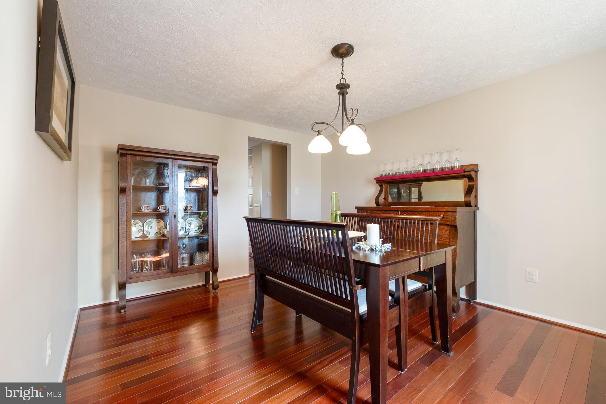 4401 Cub Run Road Chantilly, VA 20151 - Photo 21 of 60 a view of a dining room with furniture wooden floor and chandelier