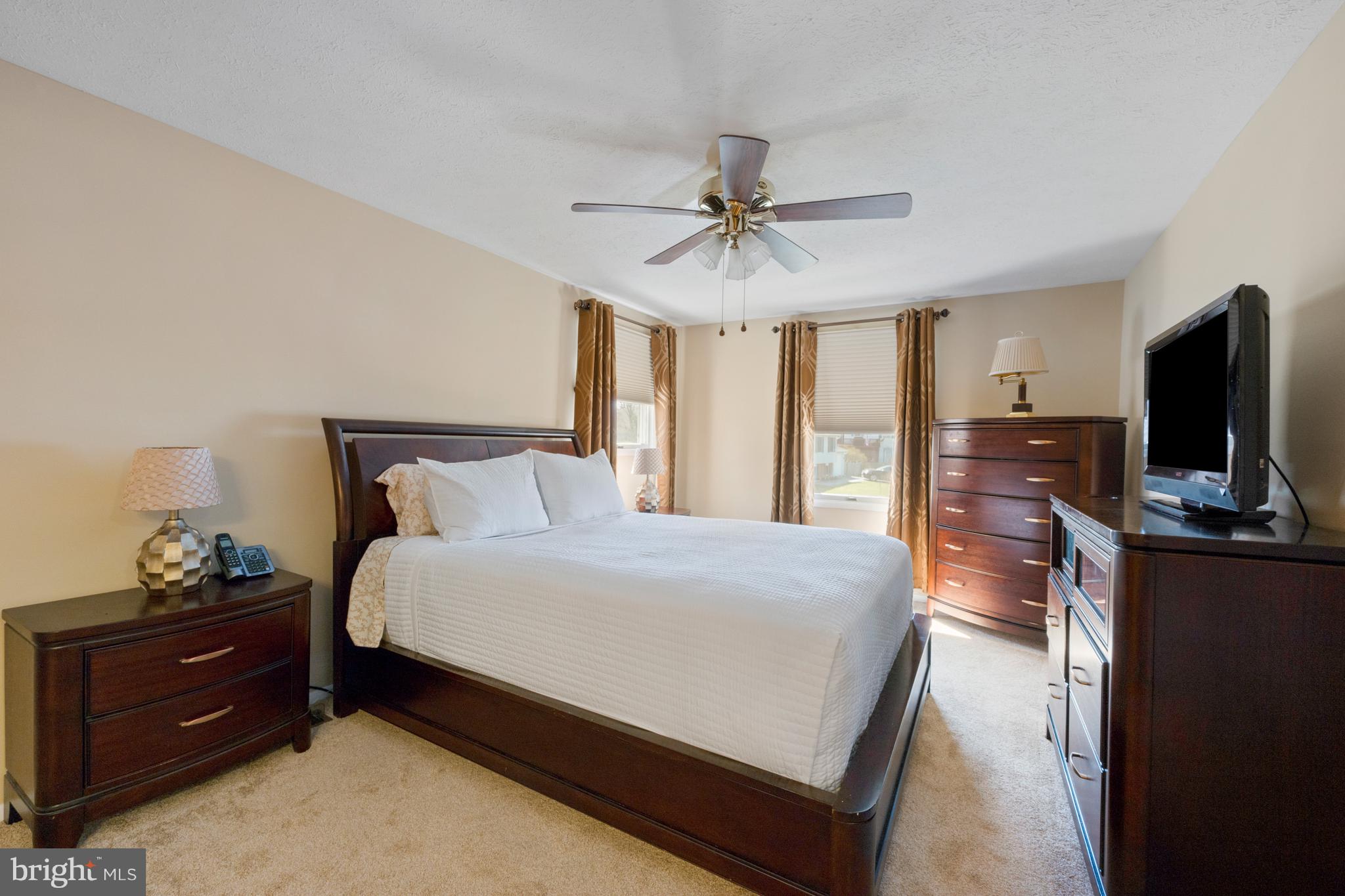 4401 Cub Run Road Chantilly, VA 20151 - Photo 27 of 60 a bedroom with a bed and a flat tv screen on dresser