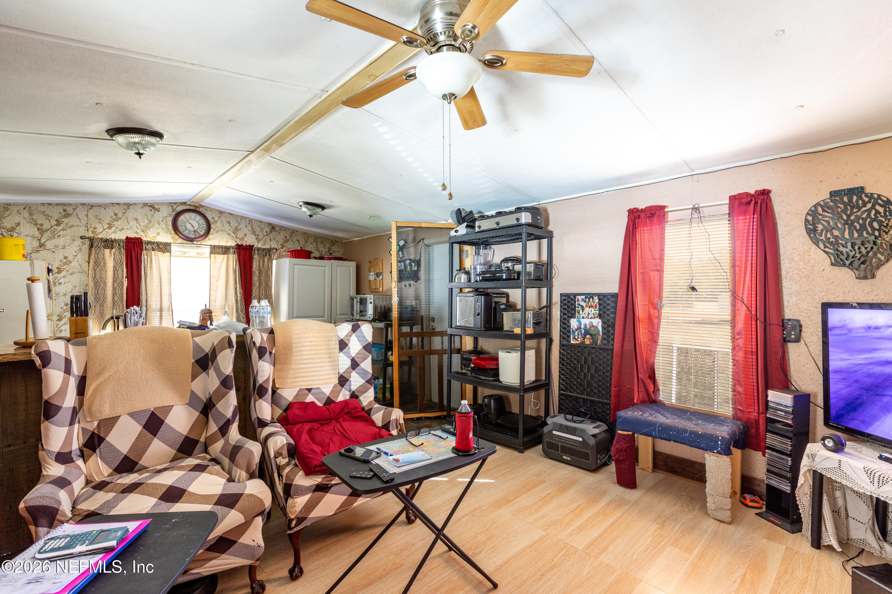 11830 Southwest 45th Terrace Lake Butler, FL 32054 - Photo 12 of 16 a living room with lots of furniture and a flat screen tv