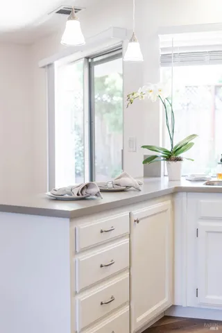 a bathroom with a granite countertop sink mirror and window