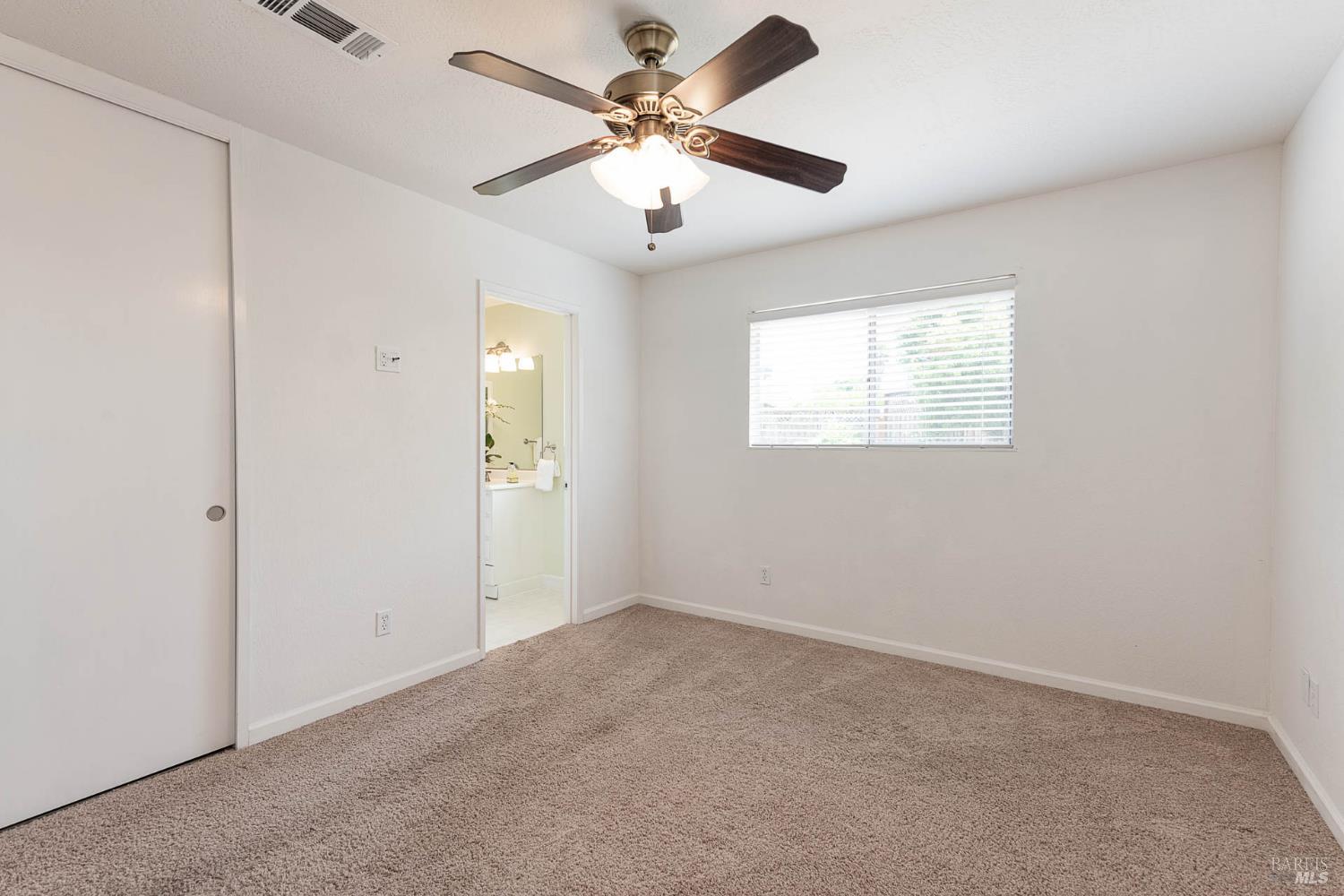 2454 Dunaway Drive Santa Rosa, CA 95403 - Photo 16 of 17 an empty room with windows and fan