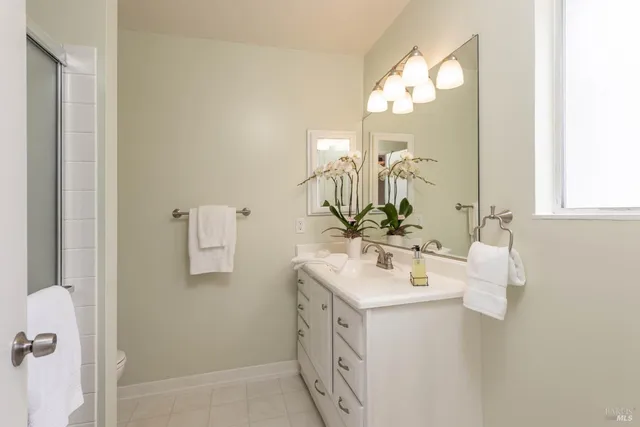 a bathroom with a sink vanity and a mirror