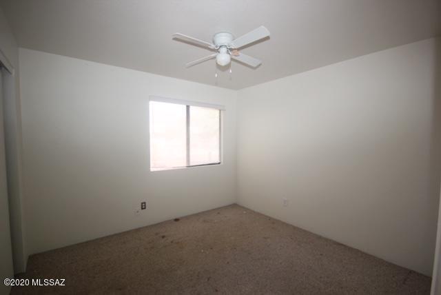 2841 West Firebrook Road Tucson, AZ 85741 - Photo 11 of 15 an empty room with a window and a fan