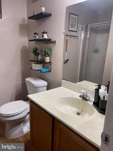 a bathroom with a sink toilet and a mirror