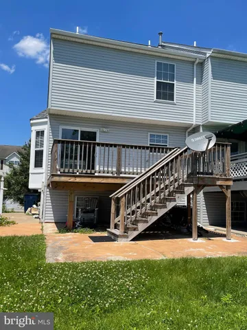 a view of a house with a balcony and a yard