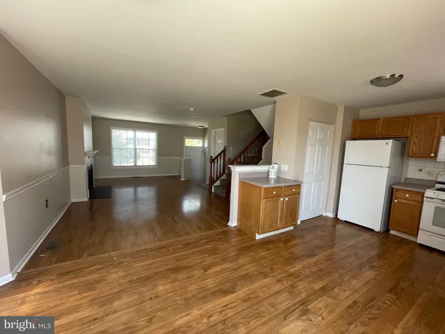 a view of a kitchen with a sink and dishwasher wooden floor