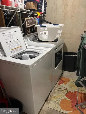 a utility room with a sink washer and dryer