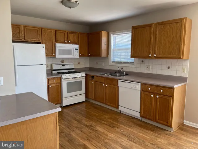 a kitchen with a sink a stove and cabinets