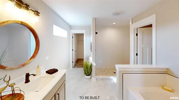 a bathroom with a tub sink and mirror