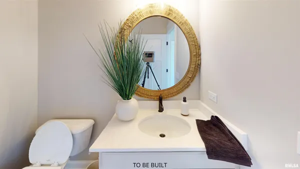 a bathroom with a toilet mirror and tub