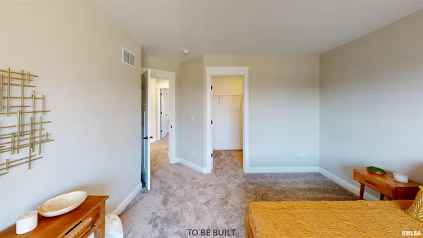 a spacious bedroom with a bed and a couch