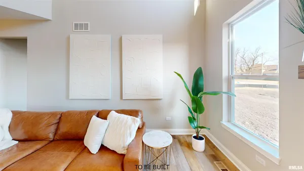 a living room with furniture and a potted plant
