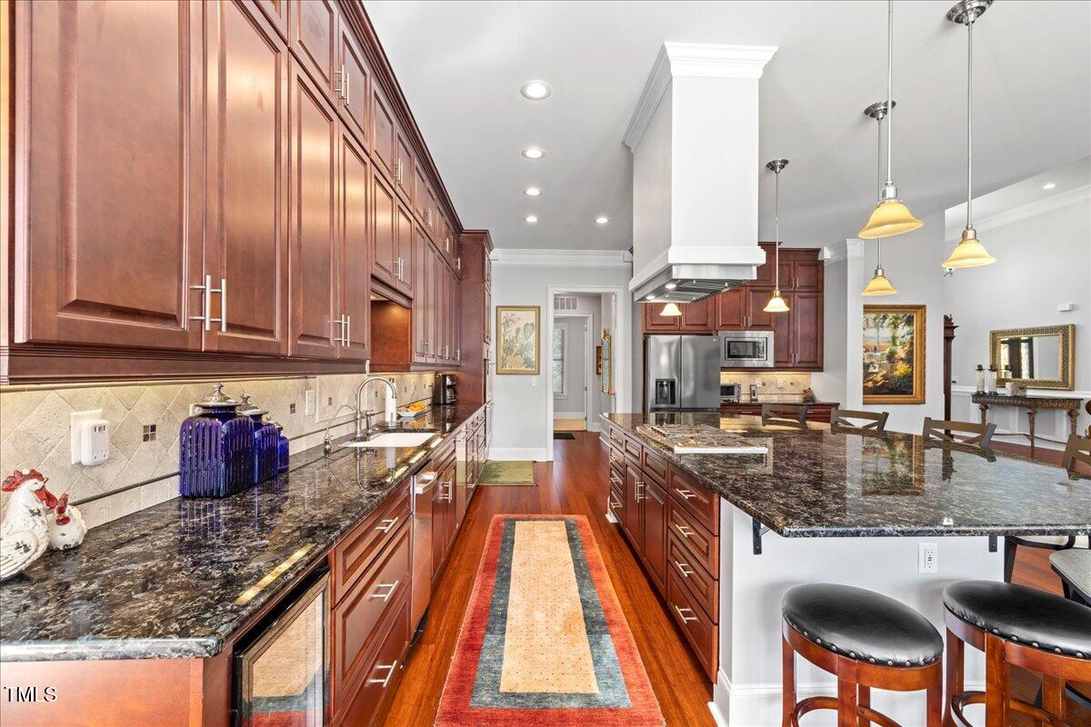 2304 Gresham Lake Road Raleigh, NC 27615 - Photo 15 of 55 a kitchen with stainless steel appliances granite countertop a stove and cabinets