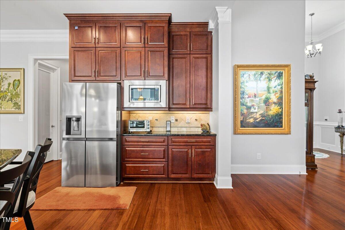 2304 Gresham Lake Road Raleigh, NC 27615 - Photo 21 of 55 a kitchen with stainless steel appliances granite countertop a refrigerator and microwave