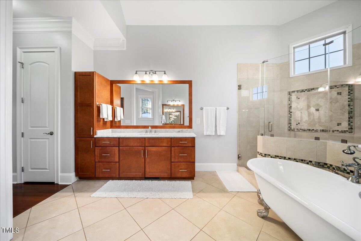2304 Gresham Lake Road Raleigh, NC 27615 - Photo 31 of 55 a spacious bathroom with a tub sink and mirror