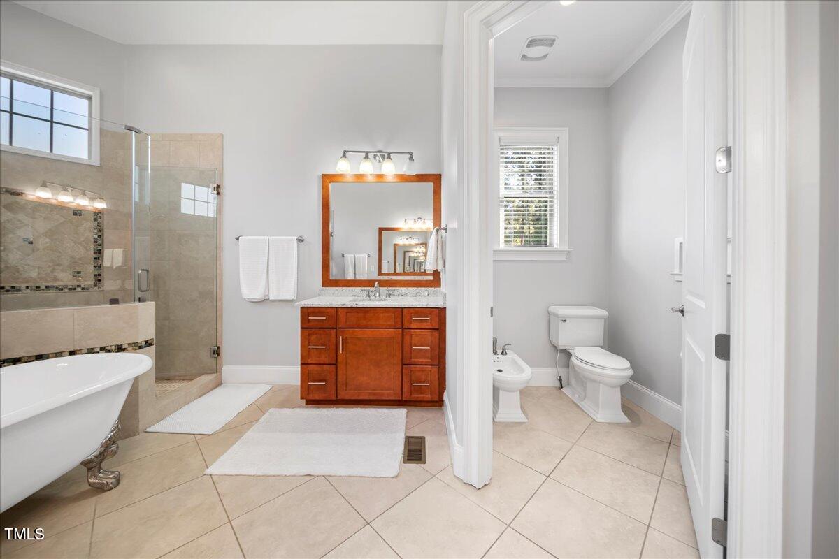 2304 Gresham Lake Road Raleigh, NC 27615 - Photo 32 of 55 a spacious bathroom with a toilet sink and mirror