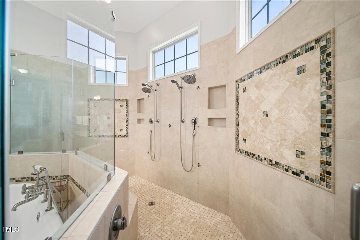 2304 Gresham Lake Road Raleigh, NC 27615 - Photo 33 of 55 a bathroom with a tub sink a shower and a mirror