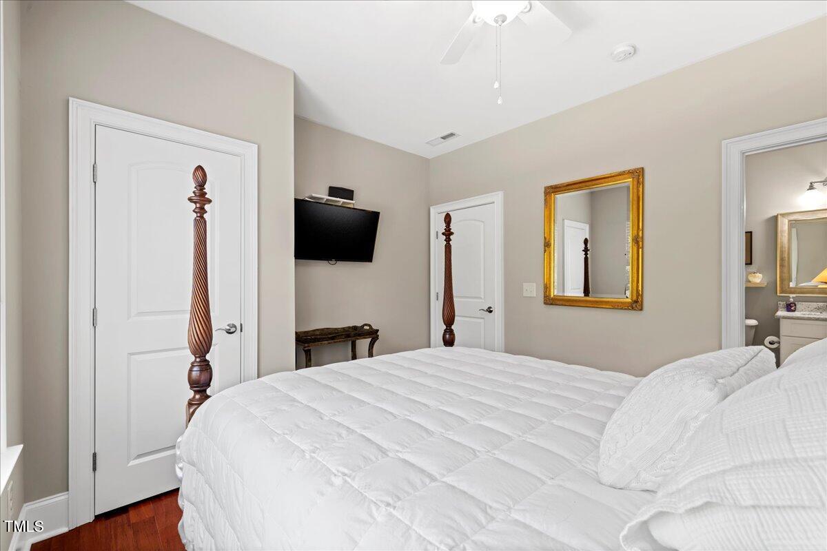 2304 Gresham Lake Road Raleigh, NC 27615 - Photo 38 of 55 a bedroom with a bed and a flat tv screen on dresser