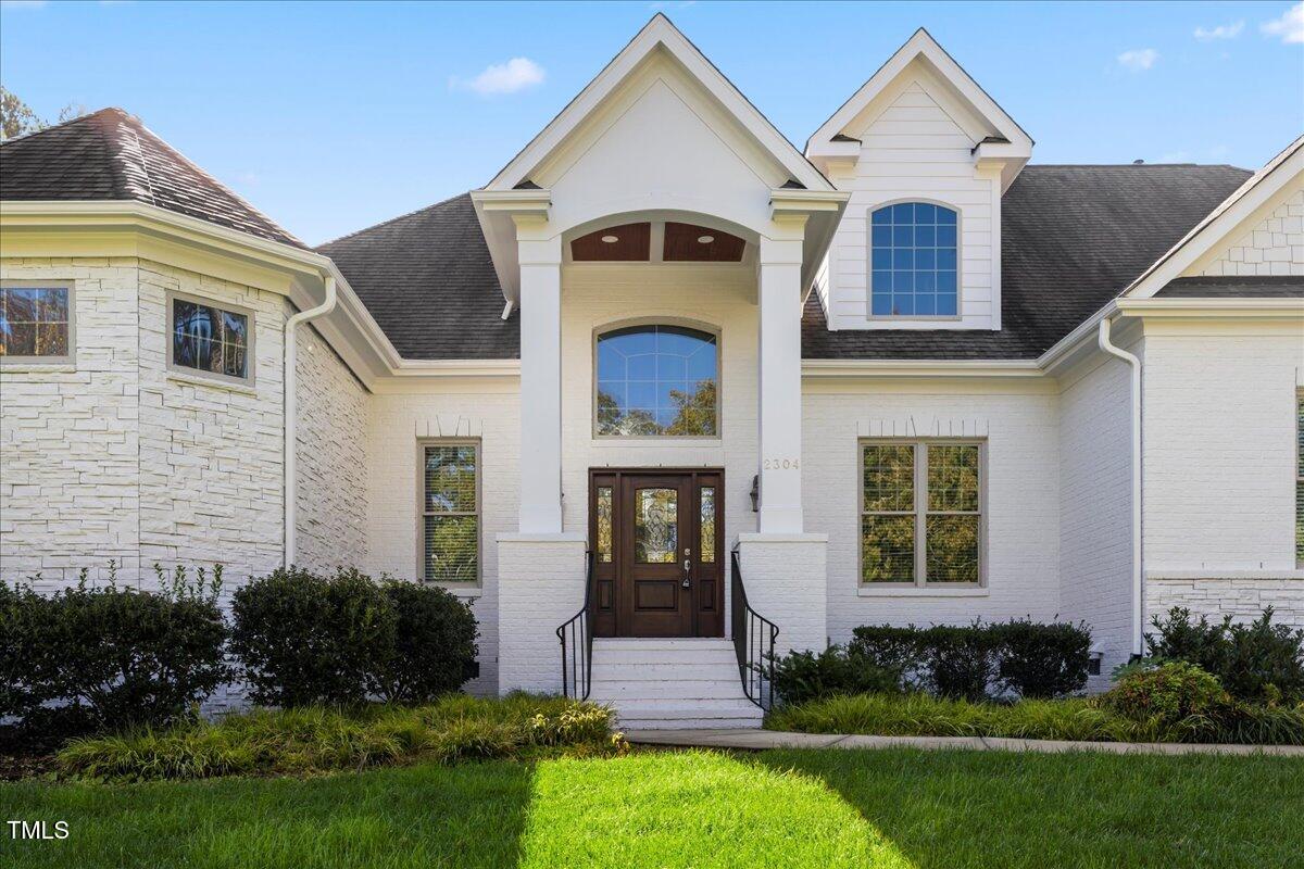2304 Gresham Lake Road Raleigh, NC 27615 - Photo 4 of 55 a front view of a house with a yard
