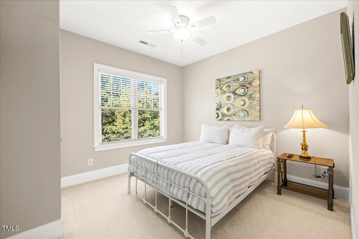 2304 Gresham Lake Road Raleigh, NC 27615 - Photo 41 of 55 a bedroom with a bed and a chandelier