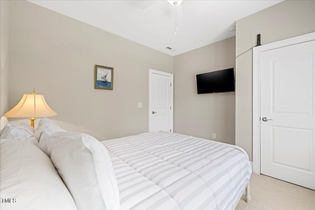 2304 Gresham Lake Road Raleigh, NC 27615 - Photo 42 of 55 a bedroom with a bed and a flat screen tv