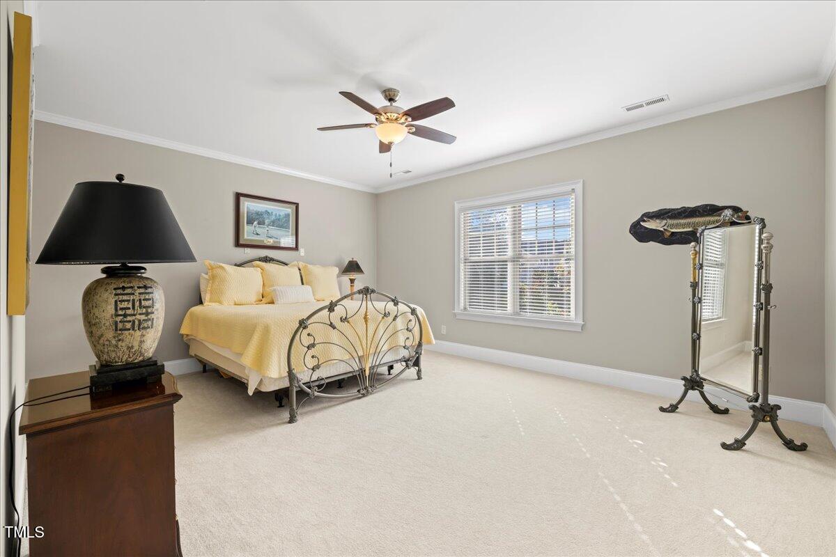 2304 Gresham Lake Road Raleigh, NC 27615 - Photo 43 of 55 a bedroom with a bed and a chandelier