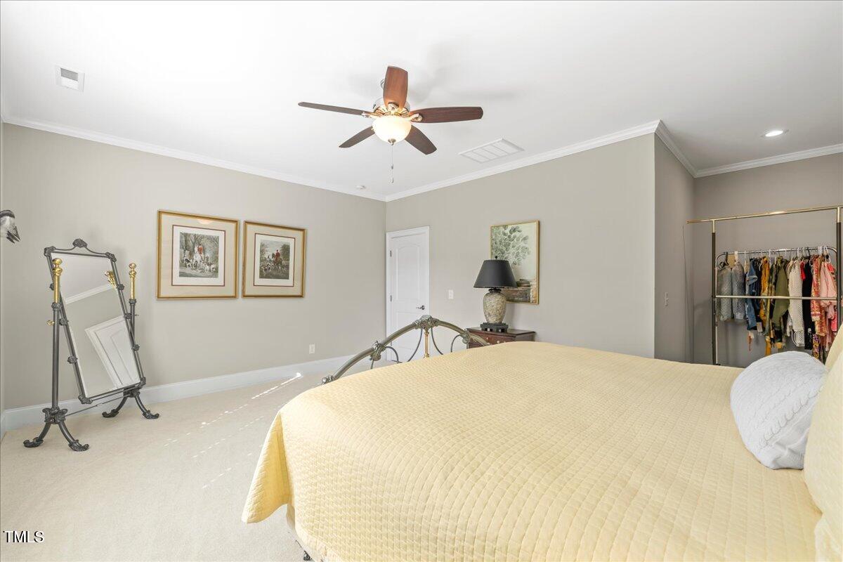 2304 Gresham Lake Road Raleigh, NC 27615 - Photo 44 of 55 a bedroom with a bed and a chandelier