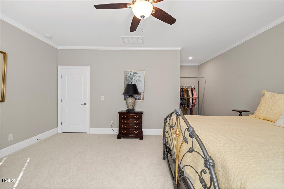 2304 Gresham Lake Road Raleigh, NC 27615 - Photo 45 of 55 a bed room with a bed and a chandelier