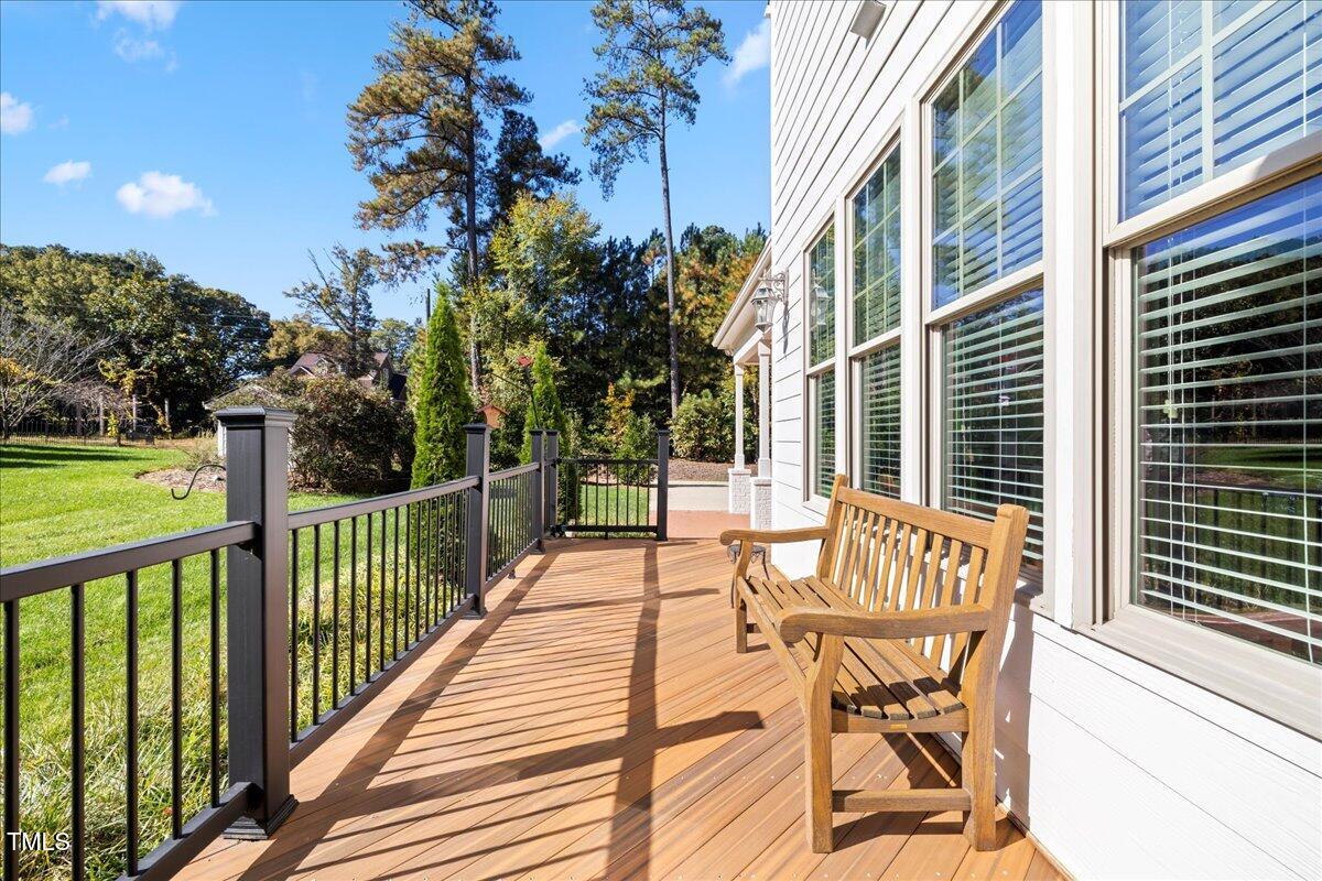 2304 Gresham Lake Road Raleigh, NC 27615 - Photo 50 of 55 a view of a patio with table and chairs and wooden floor