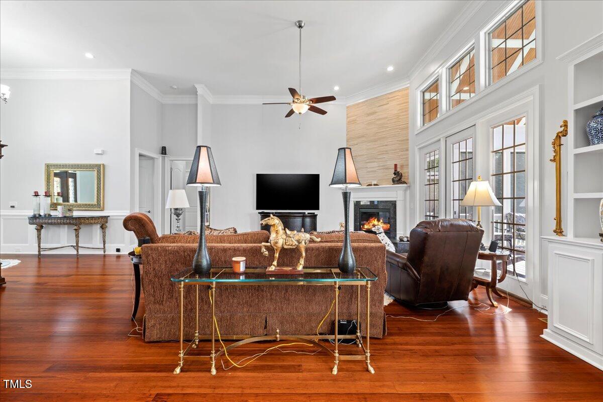 2304 Gresham Lake Road Raleigh, NC 27615 - Photo 9 of 55 a view of a livingroom with furniture a flat screen tv and wooden floor