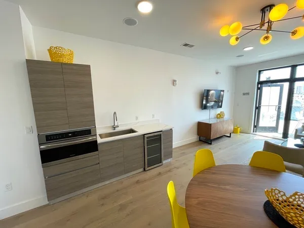 a view of a dining room with furniture and wooden floor