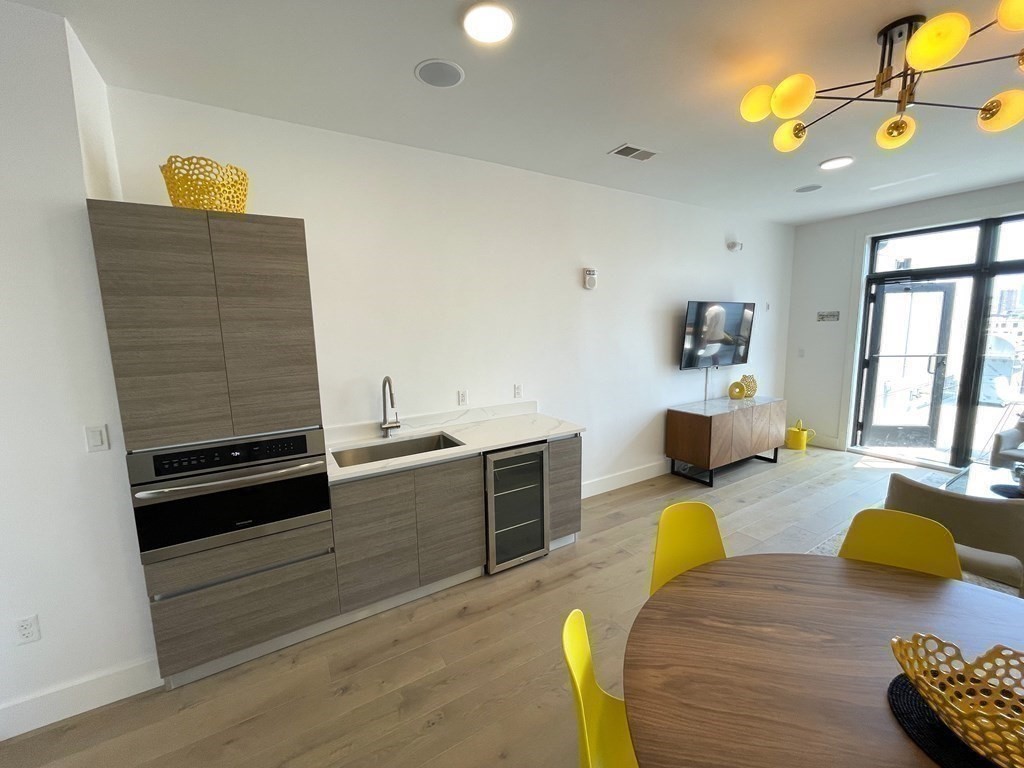 30 Penniman Road, Unit 507 Boston, MA 02134 - Photo 15 of 22 a living room with furniture and a flat screen tv