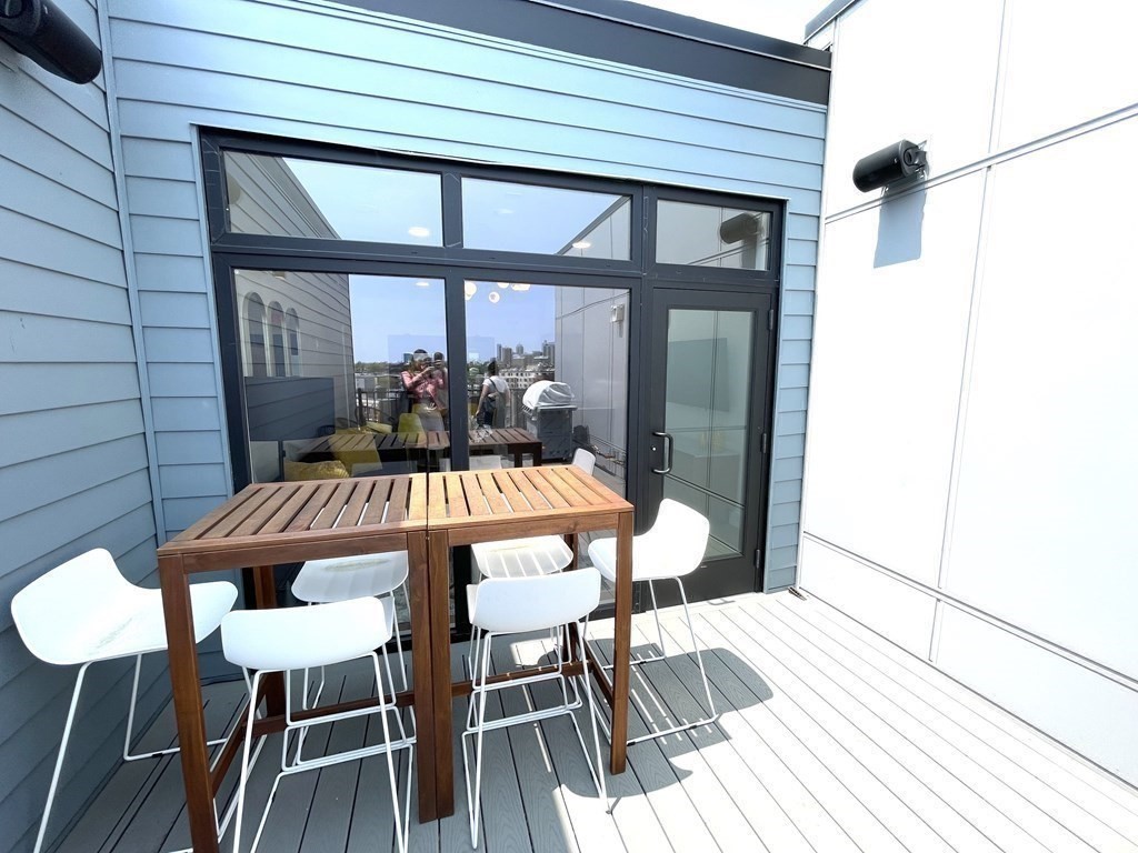 30 Penniman Road, Unit 507 Boston, MA 02134 - Photo 17 of 22 a view of a dining room with furniture and wooden floor