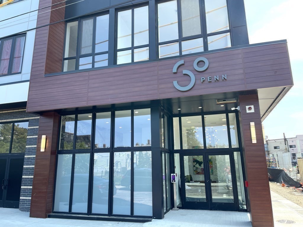 30 Penniman Road, Unit 507 Boston, MA 02134 - Photo 2 of 22 a front view of a brick building with a large window